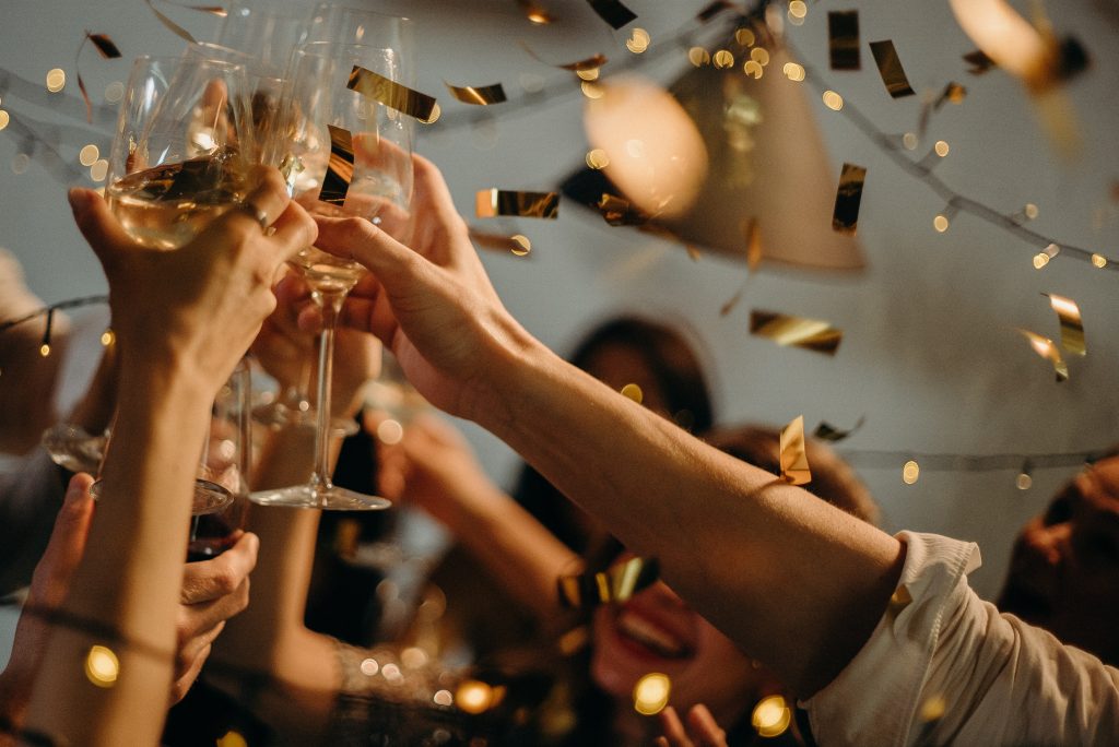 Party scene with people clinking glasses in celebration