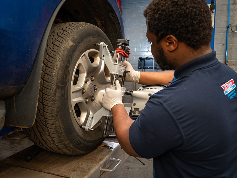 Technician at K Brown Auto Repairs working on wheel alignment