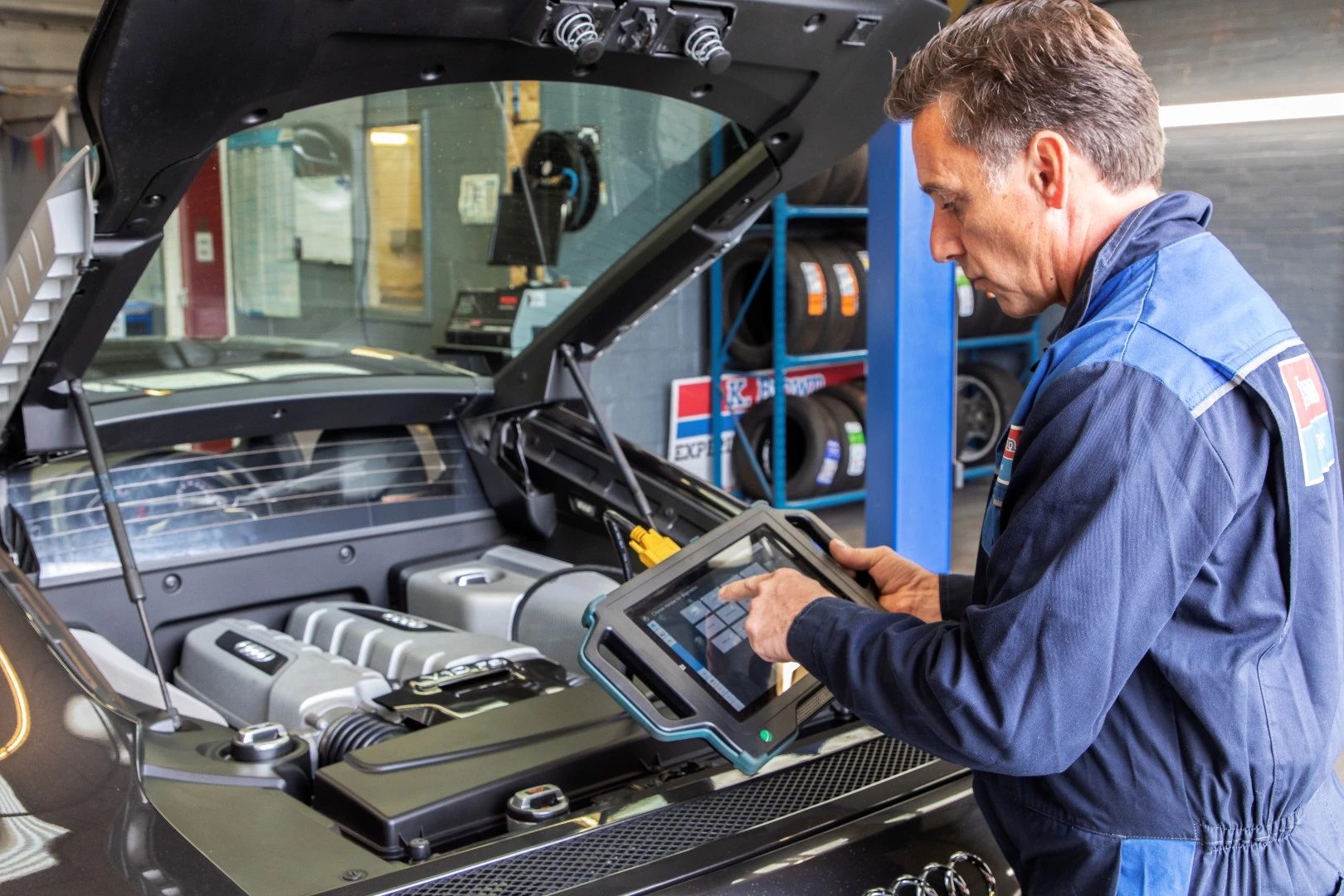 Keith Brown co-director of K Brown Auto Repairs using diagnostic equipment